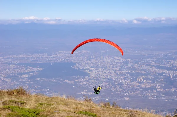 Red paraglider over city Sofia, Bulgaria — Stock Photo, Image