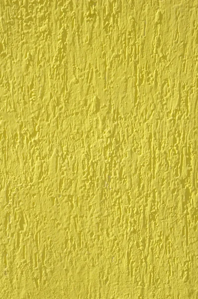 Gesso alívio amarelo na parede closeup — Fotografia de Stock