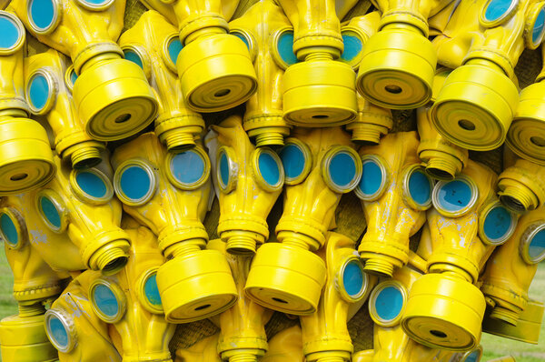 Many yellow gas masks with blue glass