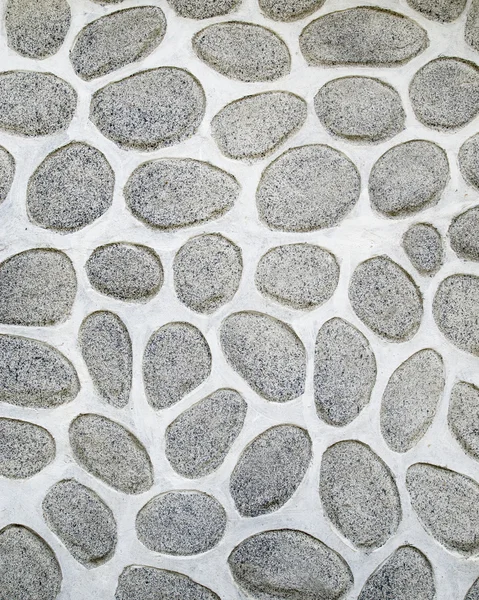 A wall of large rounded boulders with white joints — Stock Photo, Image