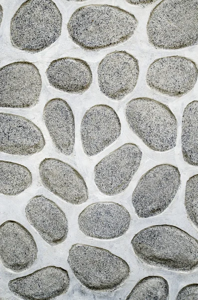 A wall of large rounded boulders with white joints — Stock Photo, Image