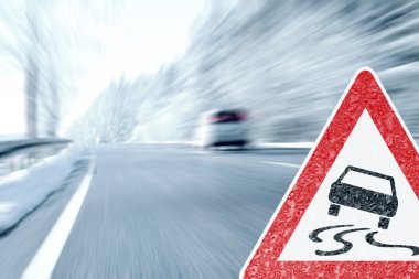 Winter Driving - Icy Road with Warning Sign clipart
