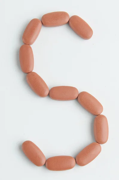 Carta s com pílulas — Fotografia de Stock