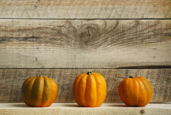 Three Pumpkins on Old  Wooden Background — Stock Photo, Image