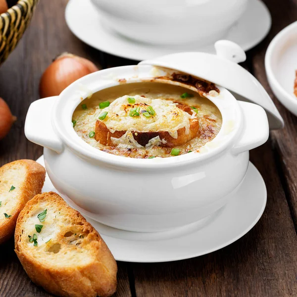 Homemade French onion soup with toasted baguette and melted cheese.