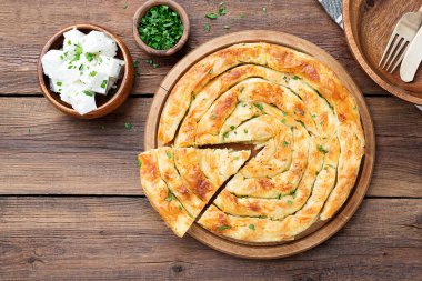 Traditional feta cheese phyllo pastry pie.  top view clipart