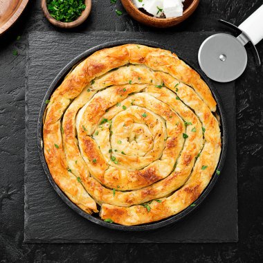 Traditional feta cheese phyllo pastry pie. top view clipart