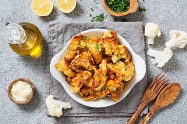 Vegetarian food. Baked cauliflower with herbs and parmesan cheese.	