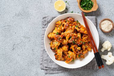 Buffalo Cauliflower . Popular Baked Cauliflower with barbeque sauce. Barbecue Cauliflower Wings . Vegan Food.	