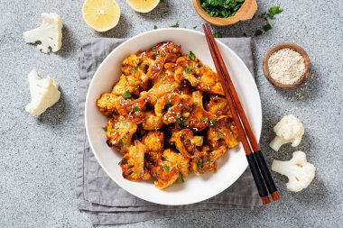 Buffalo Cauliflower . Popular Baked Cauliflower with barbeque sauce. Barbecue Cauliflower Wings . Vegan Food.	