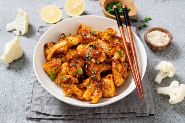 Buffalo Cauliflower . Popular Baked Cauliflower with barbeque sauce. Barbecue Cauliflower Wings . Vegan Food.	