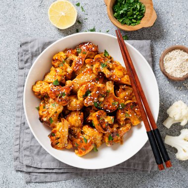 Buffalo Cauliflower . Popular Baked Cauliflower with barbeque sauce. Barbecue Cauliflower Wings . Vegan Food.	