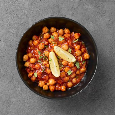 Traditional Indian dish chickpea chana masala with rice and flatbread.	