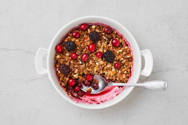Cranberry crumble pie, crispy in a baking dish.Light grey background. Top view.		