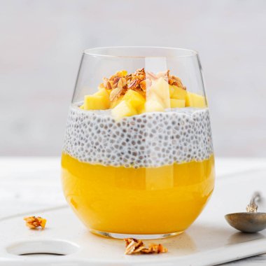 Mango püresi ve granola ile vejetaryen chia pudingi. .