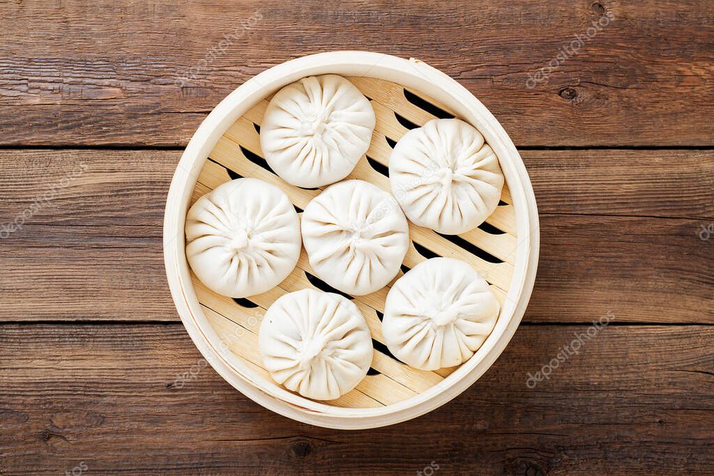 Raw dumplings Dim Sum in bamboo steamer. isolated on white background