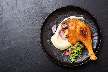 Kızarmış ördek bacağı, patates püresi ve taze salata..