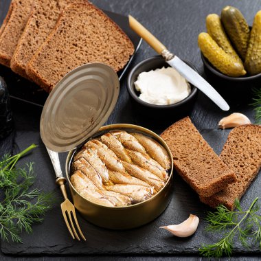 Teneke kutuda konserve makarna ve siyah arka planda sandviç yapmak için ekmek..