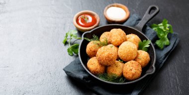 Potato croquettes - mashed potatoes balls breaded and deep fried, served with different sauce. clipart