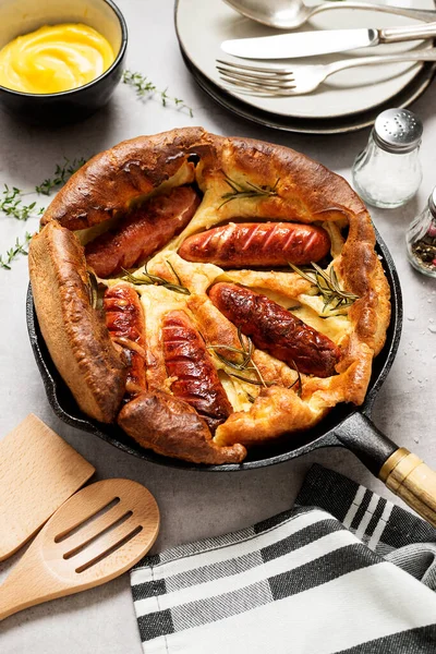 Toad in the hole, Sausage Toad, traditional English dish of sausages in Yorkshire pudding batter.