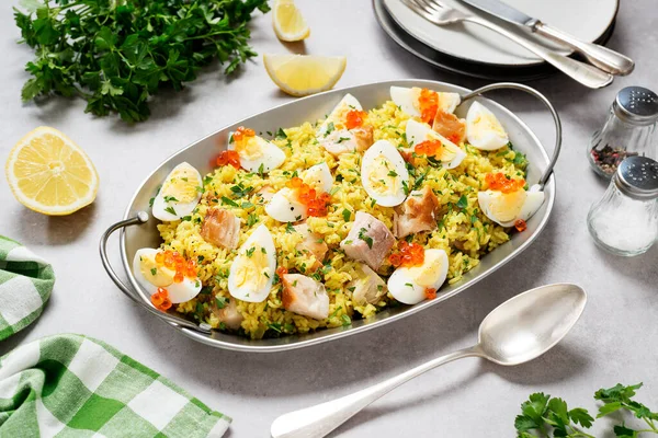 Traditional british cuisine. Fresh prepared kedgeree with smoked haddock and boiled egg. Served with fresh parsley and red caviar.