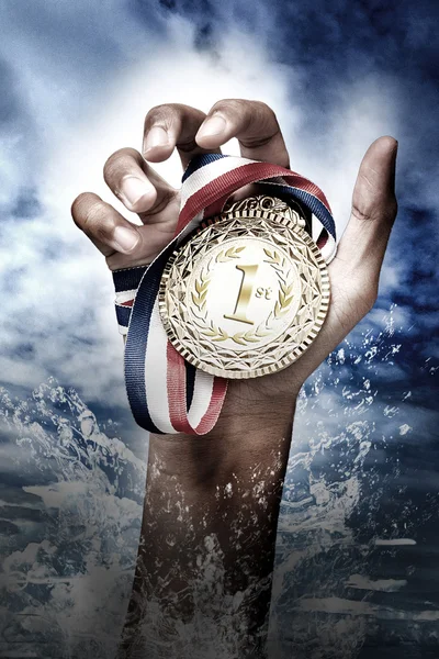 Hand holding up a gold trophy — Stock Photo, Image
