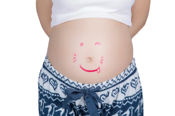 Rotes fröhliches Smiley-Gesicht auf dem Bauch einer Schwangeren lizenzfreie Stockbilder