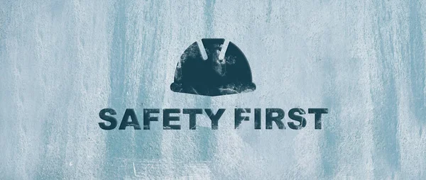 safety first sign on wall background