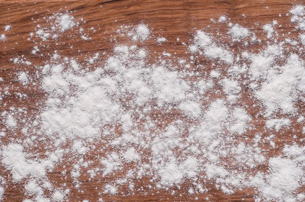 Flour on brown wooden table — Stock Photo, Image