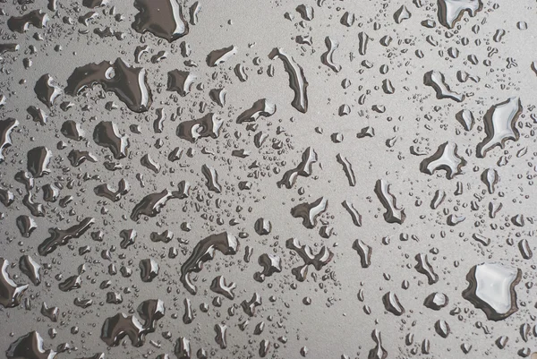 Gotas de agua en la superficie negra —  Fotos de Stock