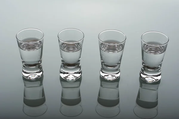 Four shots of vodka — Stock Photo, Image