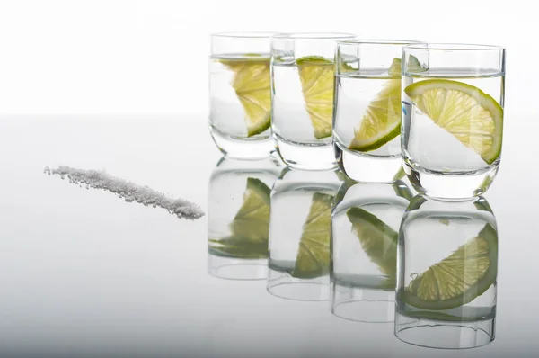 Four shots of vodka with lemon — Stock Photo, Image