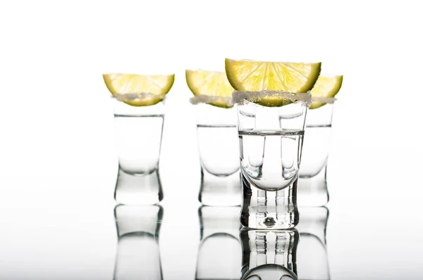 Four shots of vodka with lemon — Stock Photo, Image