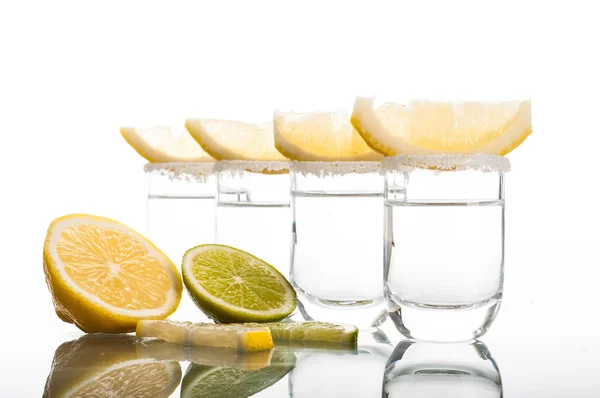 Four shots of vodka with lemon — Stock Photo, Image