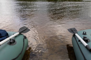 Şişirilebilir kürekli yeşil tekne. Seyahat ve aktif yaşam tarzı kavramı.