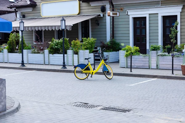 A bicycle is parked. Bicycle priority concept over a machine. Idea Green City.