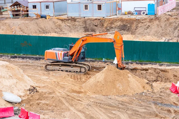 Excavator in action, digging land for construction.