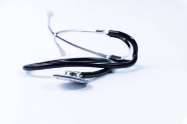 Siyah tıbbi steteskop beyaz arka planda izole edilmiş.