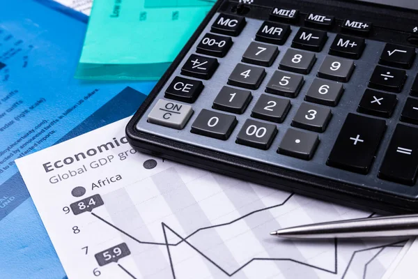 Business background with charts, pen and calculator