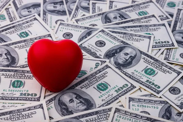 Red heart on a background of dollars