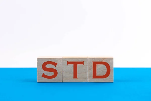 Std Inscription Wooden Cubes Blue Background — Stock Photo, Image