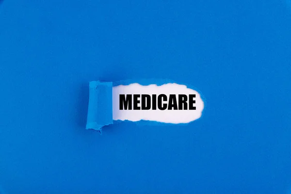 Texte Medicare Apparaissant Derrière Papier Bleu Déchiré — Photo