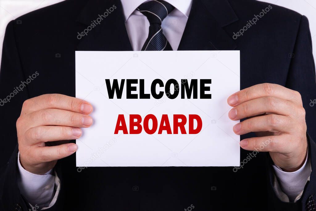 Businessman holding a card with text Welcome Aboard