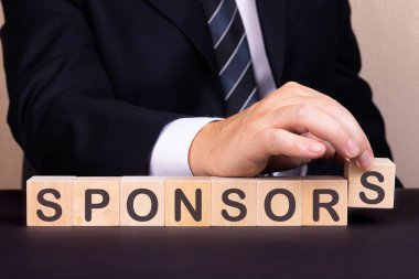 İnsanlar tahta bloklarla kelime sponsoru yaptılar.