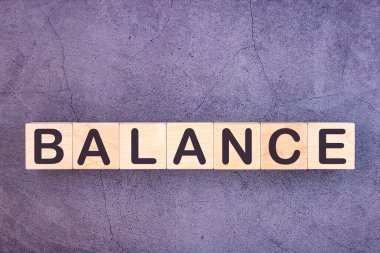 Tahta yapı taşlarından yapılmış denge kelimesi.