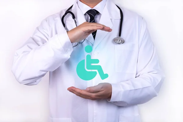 Conceptual image, care for handicapped person.A doctor with a stethoscope holds his hands as a symbol of protection.