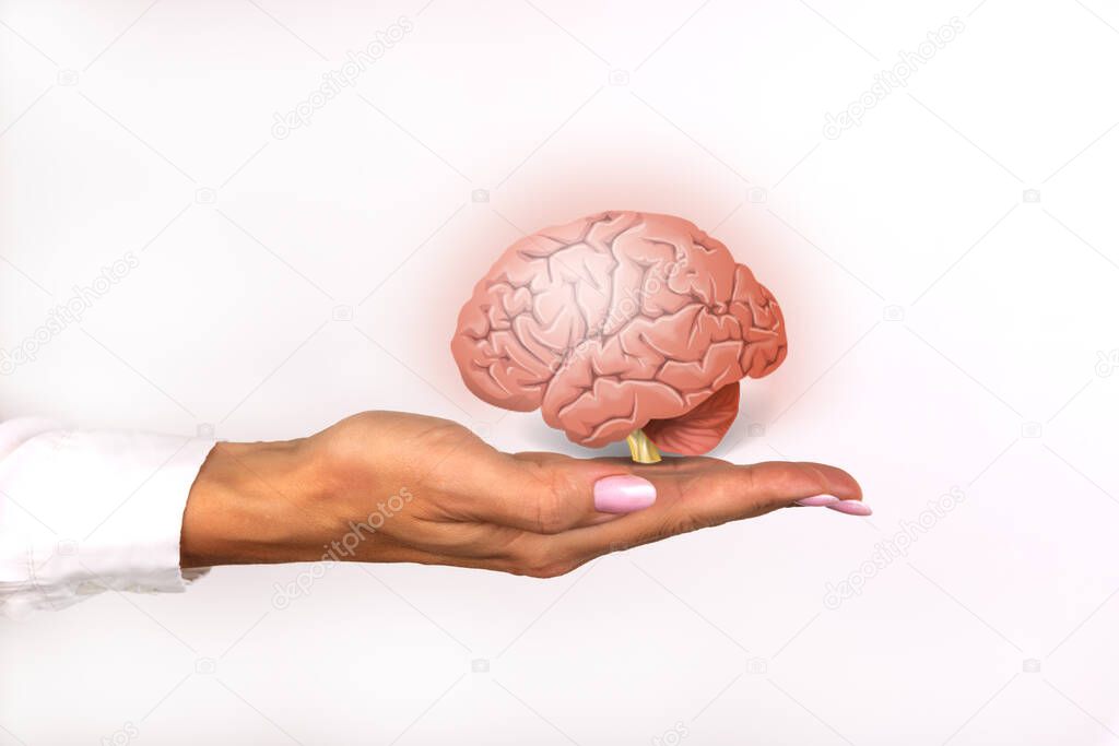 Brain icon on a female hand. Brain disease protection concept.