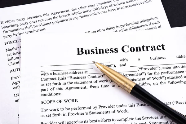 The pen lies on the contract. Business relationship concept.