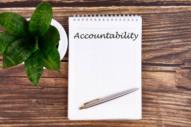 Hand writing inscription Accountability - text on notebook with a pen clipart