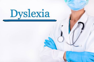 DYSLEXIA yazılı, hafif arka planda tıbbi kıyafetli bir doktor. Tıbbi konsept.